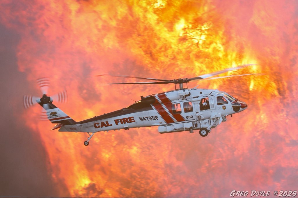 Helicopter dropping water onto fire