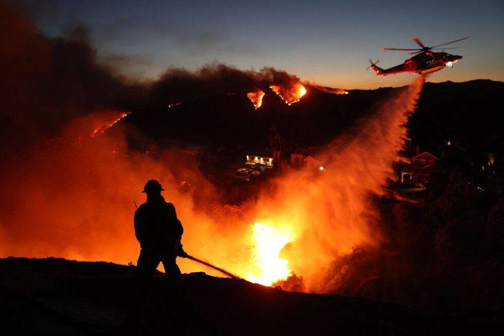 Firefighter and helicopter water drop